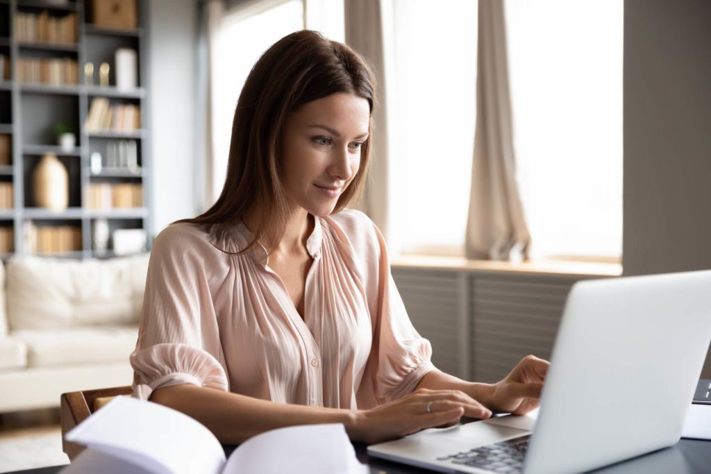 young female accountant working from home on a laptop